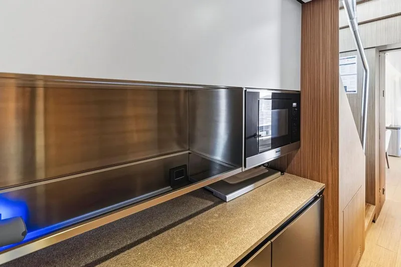 Randy Beth Yacht Photos Pics Modern kitchen area in 2018 Custom Line 120 yacht with sleek microwave and cabinetry.