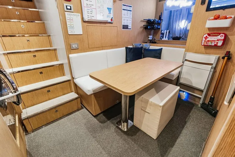 Randy Beth Yacht Photos Pics Cozy yacht interior with wooden stairs, dining area, and first aid kit, Custom Line 120, 2018.