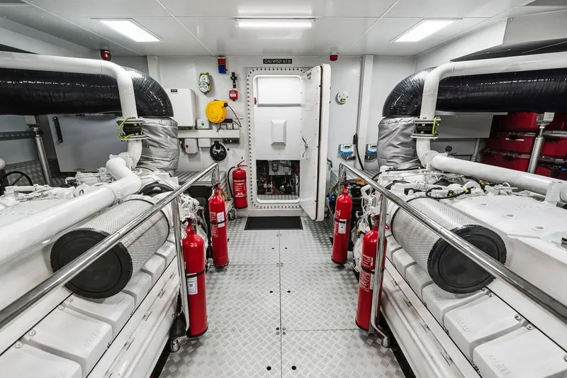 Randy Beth Yacht Photos Pics Engine room of a 2018 Custom Line 120 yacht, featuring dual engines and safety equipment.
