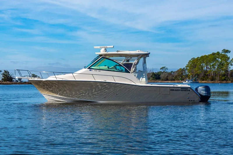 Yacht Photos Pics 2020 Grady-White 370 Express boat on calm water, clear sky background.