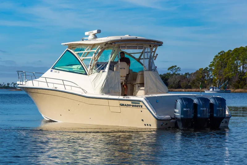  Yacht Photos Pics 2020 Grady-White 370 Express boat with triple Yamaha engines on a calm lake.