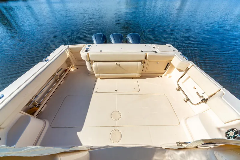  Yacht Photos Pics 2020 Grady-White 370 Express boat deck with triple outboard motors on calm water.