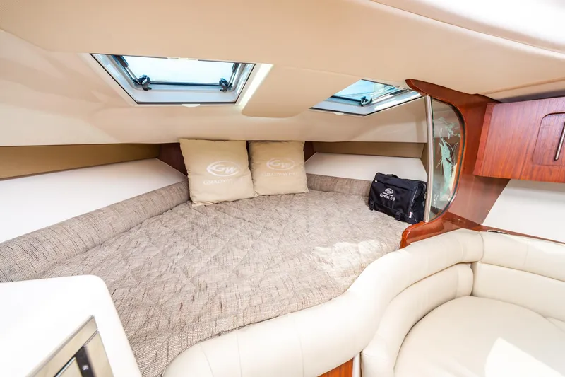  Yacht Photos Pics Luxurious cabin interior of 2020 Grady-White 370 Express with plush bedding and elegant wood accents.