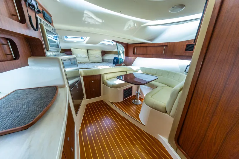 Yacht Photos Pics Interior of 2020 Grady-White 370 Express yacht with wood finish and seating area.