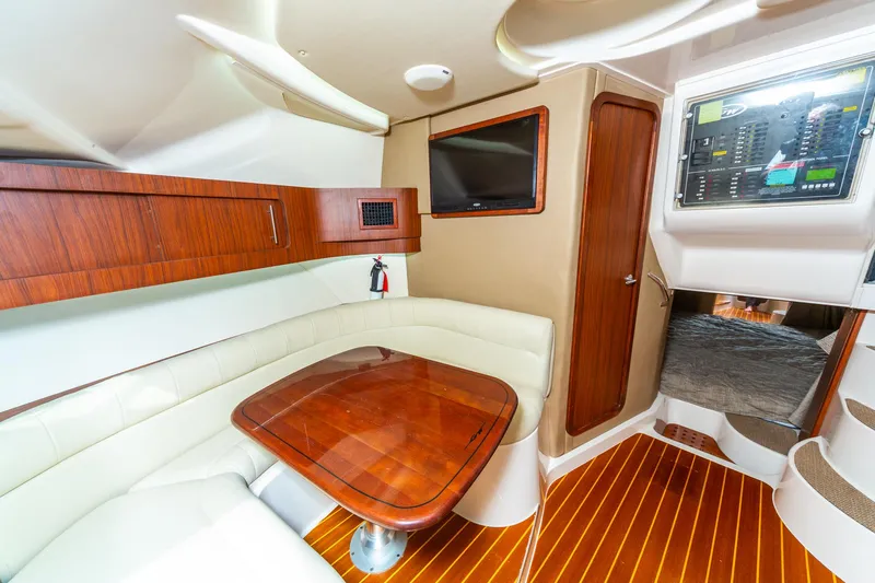  Yacht Photos Pics 2020 Grady-White 370 Express cabin interior with wood accents and seating area.