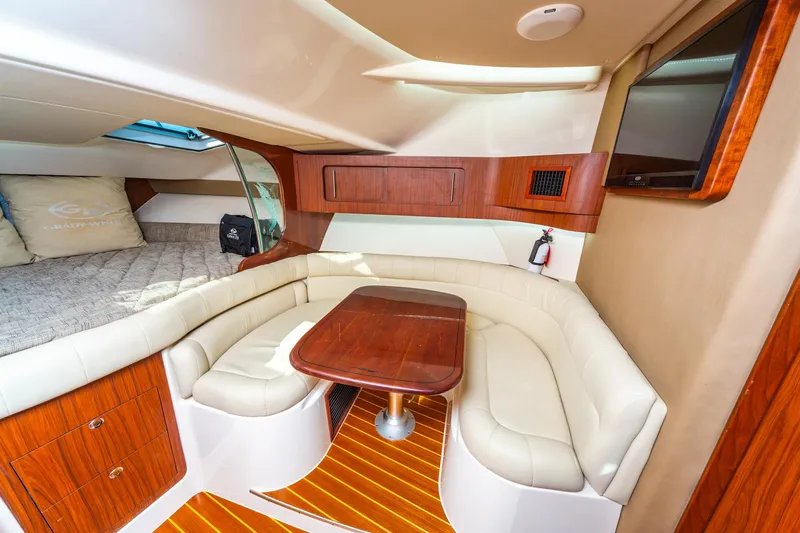  Yacht Photos Pics 2020 Grady-White 370 Express cabin interior with seating, table, and bed.