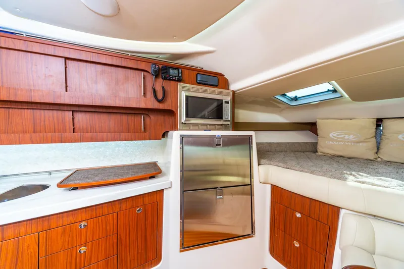 Yacht Photos Pics 2020 Grady-White 370 Express cabin interior with wood cabinetry and modern amenities.