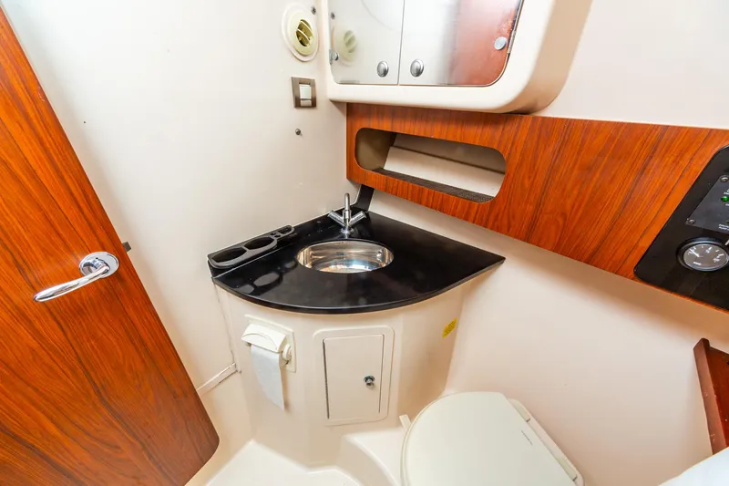  Yacht Photos Pics 2020 Grady-White 370 Express bathroom with wood accents and modern fixtures.
