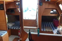 Cozy boat interior with striped bedding, wooden finish, and nautical decor, DanielP1Tester One-Off Design 2012.
