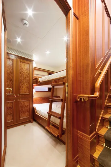  Yacht Photos Pics Luxurious wooden interior of Van der Valk Explorer 37M yacht, featuring bunk beds and elegant cabinetry.