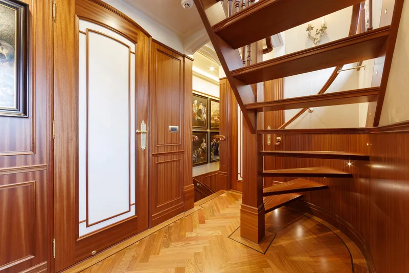  Yacht Photos Pics Luxurious wooden interior of Van der Valk Explorer 37M yacht, 2026 model, featuring elegant staircase.
