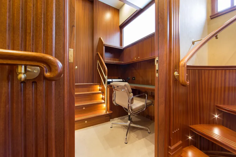  Yacht Photos Pics Luxurious wooden interior of Van der Valk Explorer 37M yacht, featuring a cozy office space.