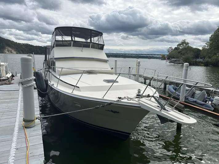 Last Dance Yacht Photos Pics 1987 Viking Boats 44 Motor Yacht docked at a marina under cloudy skies.
