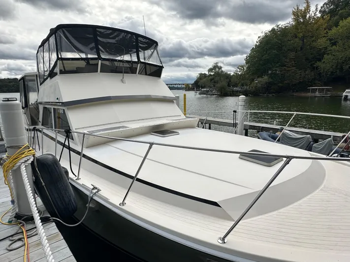 Last Dance Yacht Photos Pics 1987 Viking Boats 44 Motor Yacht docked by a serene lake.