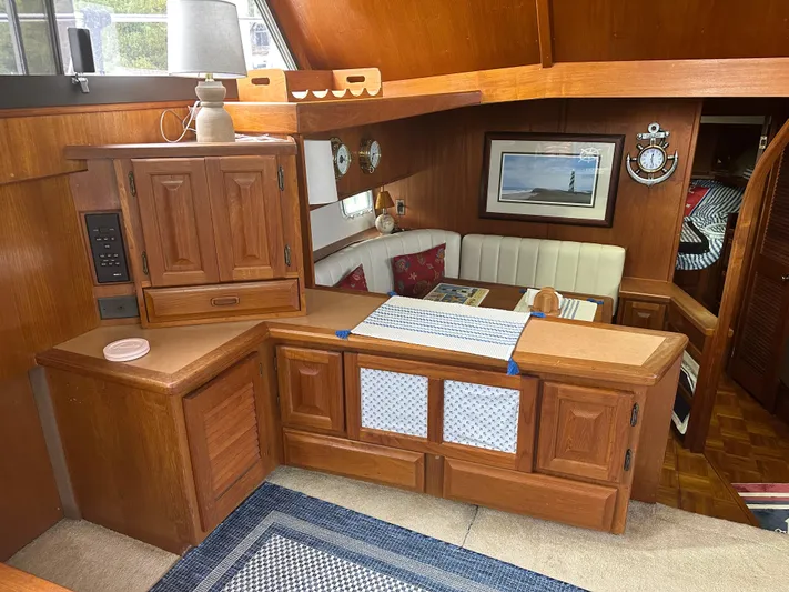 Last Dance Yacht Photos Pics Interior of 1987 Viking Boats 44 Motor Yacht with wooden cabinetry and cozy dining area.