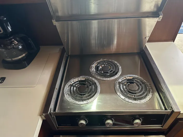 Last Dance Yacht Photos Pics Stainless steel stove in the kitchen of a 1987 Viking Boats 44 Motor Yacht.