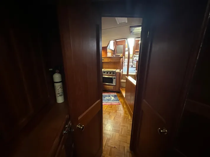 Last Dance Yacht Photos Pics 1987 Viking Boats 44 Motor Yacht interior view with kitchen and wooden cabinetry.