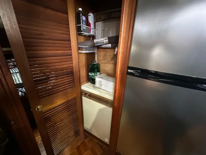 Last Dance Yacht Photos Pics Laundry area in 1987 Viking Boats 44 Motor Yacht with washer and storage shelves.