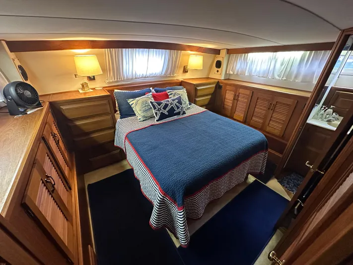 Last Dance Yacht Photos Pics 1987 Viking Boats 44 Motor Yacht bedroom with cozy bed and wooden cabinetry.