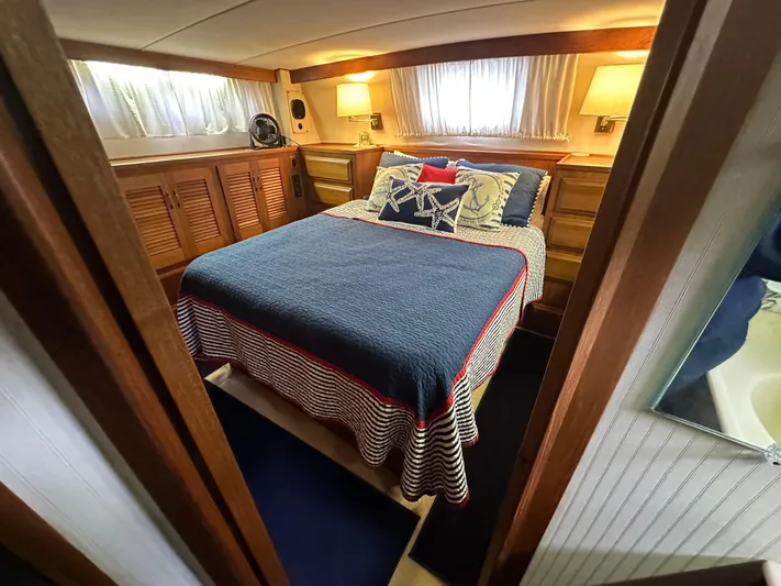 Last Dance Yacht Photos Pics 1987 Viking Boats 44 Motor Yacht bedroom with cozy bed and wooden cabinetry.