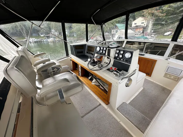 Last Dance Yacht Photos Pics 1987 Viking Boats 44 Motor Yacht helm with dual captain chairs and navigation instruments.