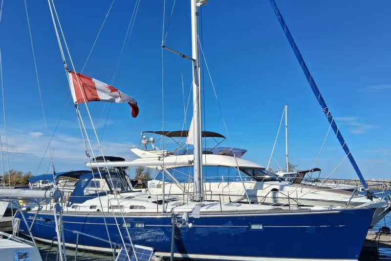 Rick B Yacht Photos Pics 2006 Beneteau 473 sailboat with Canadian flag docked in marina.