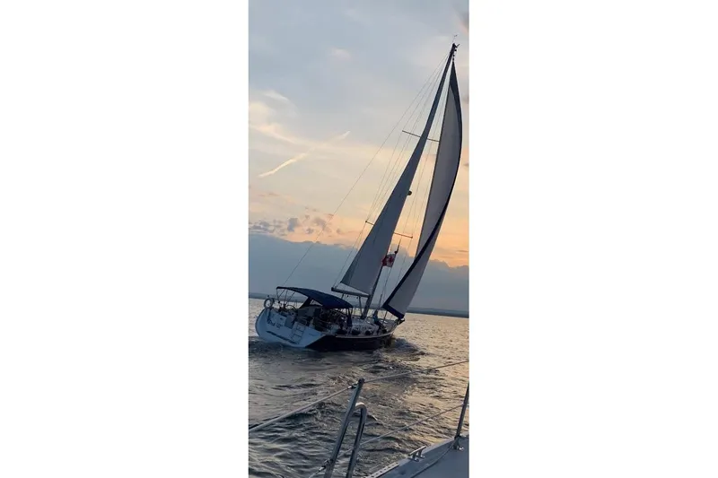 Rick B Yacht Photos Pics Sailing yacht Beneteau 473, 2006 model, gliding at sunset on open water.