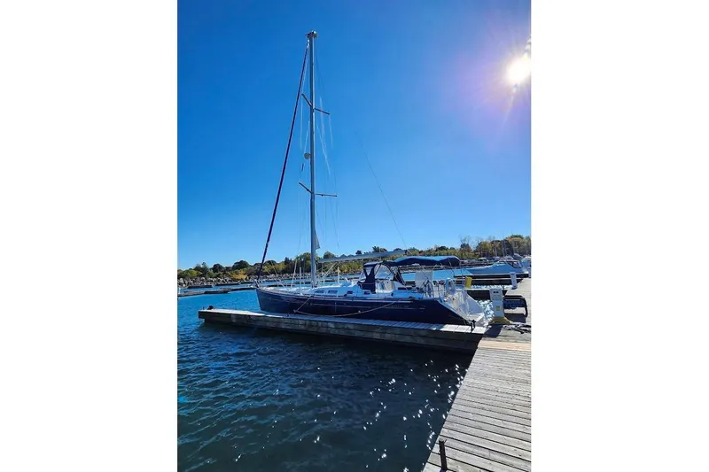 Rick B Yacht Photos Pics 2006 Beneteau 473 sailboat docked under clear blue sky.