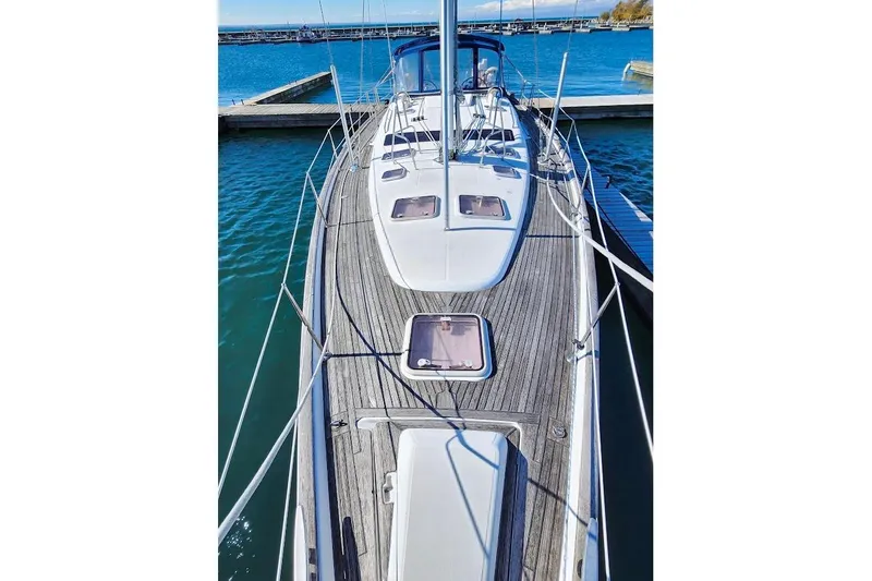 Rick B Yacht Photos Pics 2006 Beneteau 473 sailboat docked, showcasing sleek deck design and ocean backdrop.