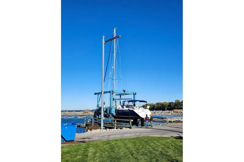 Rick B Yacht Photos Pics 2006 Beneteau 473 sailboat on a lift at a marina, clear blue sky.