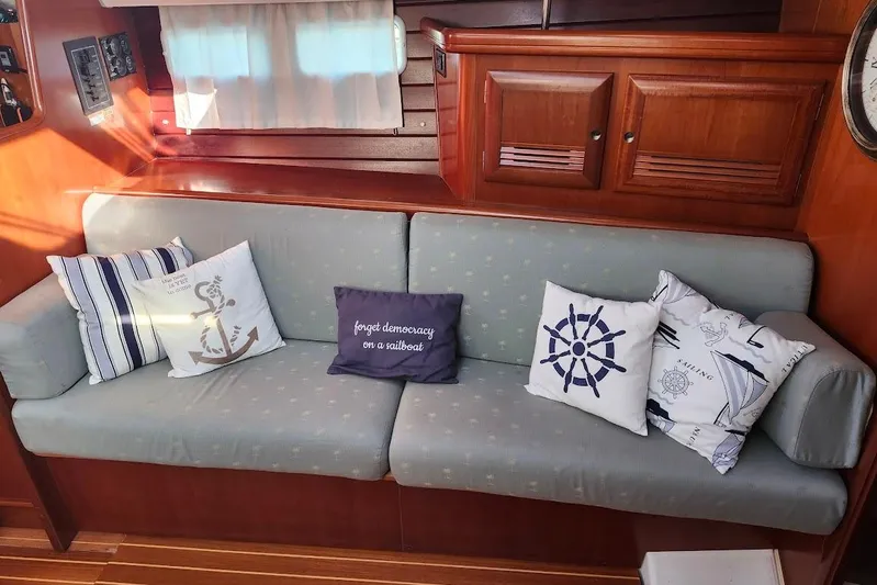 Rick B Yacht Photos Pics Interior of 2006 Beneteau 473 sailboat with nautical-themed cushions on a sofa.