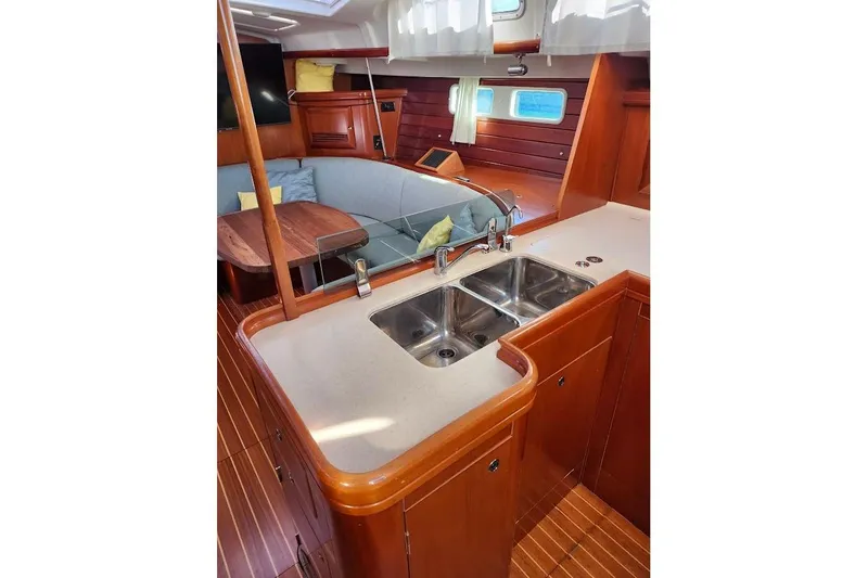 Rick B Yacht Photos Pics Interior of 2006 Beneteau 473 yacht with kitchen sink and seating area.