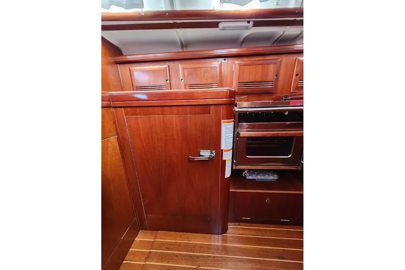 Rick B Yacht Photos Pics Interior of 2006 Beneteau 473 yacht with wooden cabinetry and built-in oven.