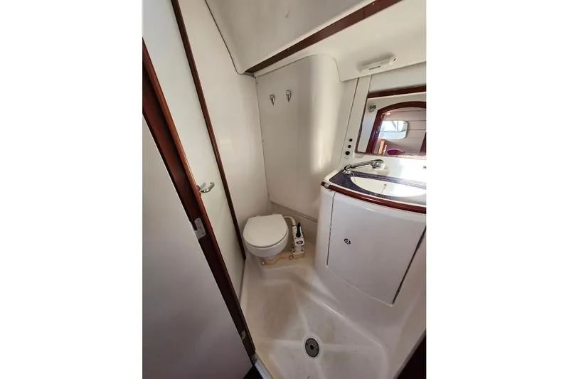 Rick B Yacht Photos Pics Bathroom interior of 2006 Beneteau 473 yacht, featuring toilet and sink.