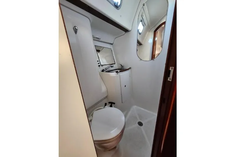 Rick B Yacht Photos Pics 2006 Beneteau 473 yacht bathroom with toilet, sink, and mirror.