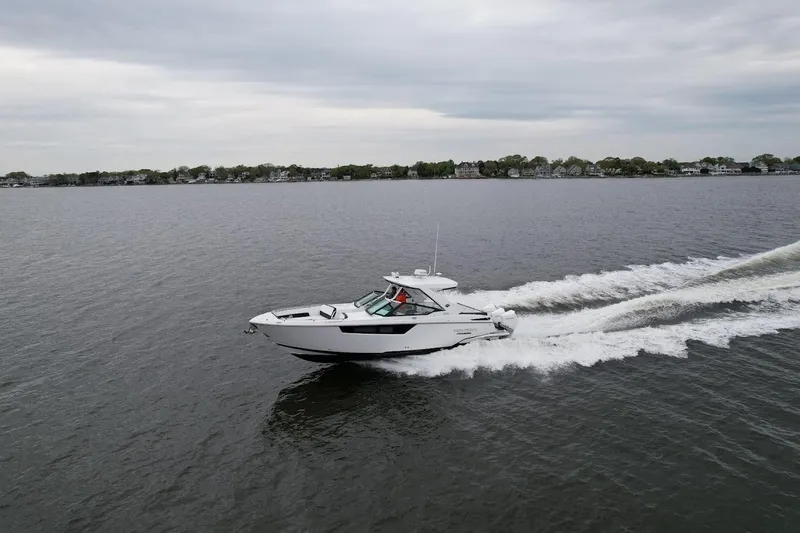  Yacht Photos Pics 2021 Monterey 385 Super Express cruising on a calm lake.