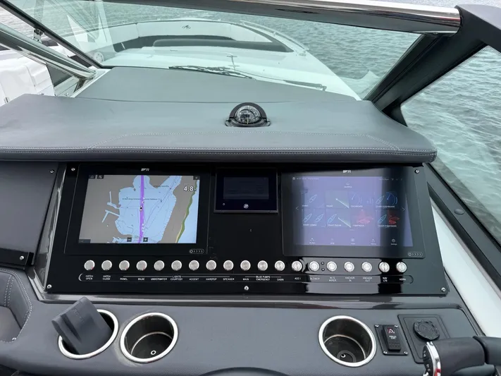  Yacht Photos Pics Dashboard of a 2021 Monterey 385 Super Express boat with navigation screens.