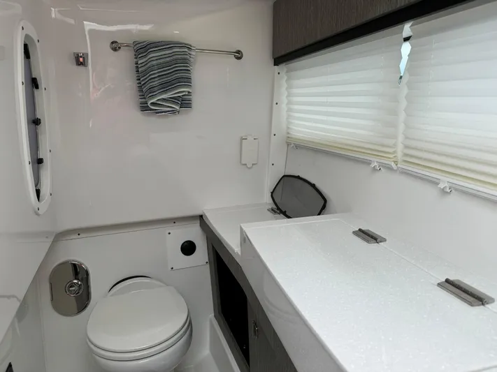  Yacht Photos Pics 2021 Monterey 385 Super Express bathroom with modern fixtures and ample counter space.
