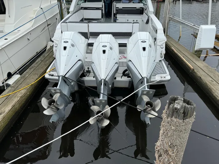  Yacht Photos Pics 2021 Monterey 385 Super Express with triple outboard engines docked at marina.