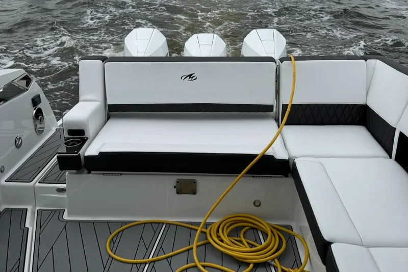  Yacht Photos Pics 2021 Monterey 385 Super Express boat with white seating and yellow hose on deck.