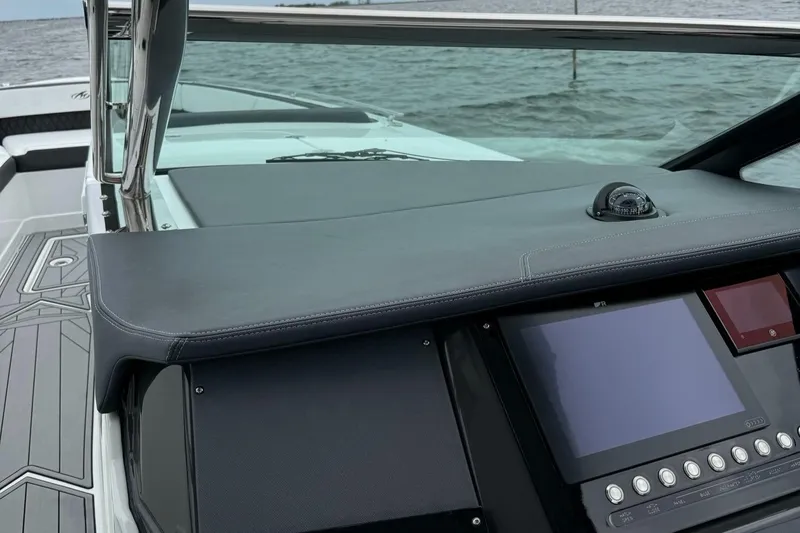  Yacht Photos Pics 2021 Monterey 385 Super Express boat dashboard with navigation screen and controls.