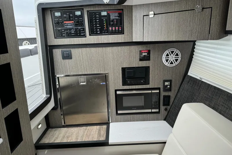  Yacht Photos Pics 2021 Monterey 385 Super Express interior control panel and kitchenette area.