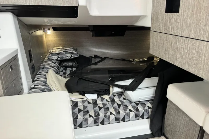  Yacht Photos Pics Interior cabin of a 2021 Monterey 385 Super Express boat with geometric-patterned bedding.