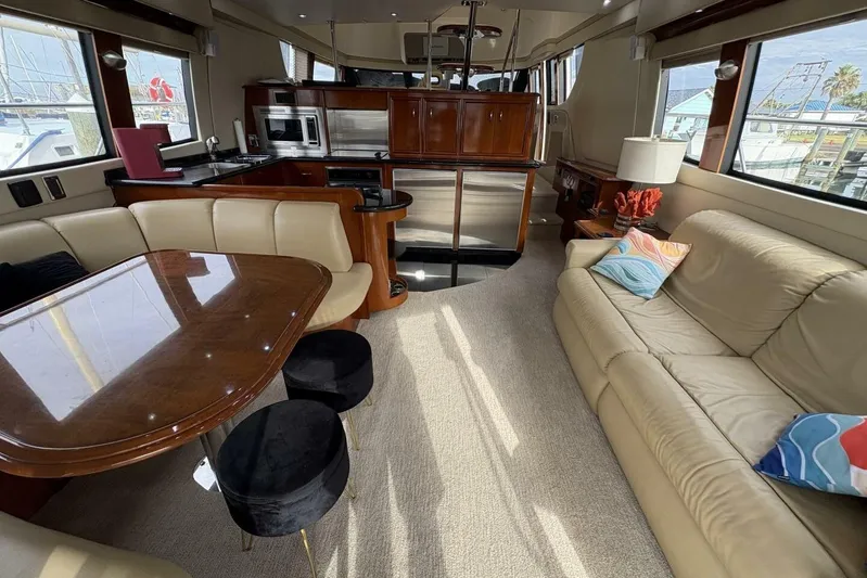 Carlet Vivian IV Yacht Photos Pics Luxurious interior of a 2004 Carver 56 Voyager yacht with elegant seating and modern kitchen.