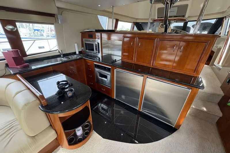 Carlet Vivian IV Yacht Photos Pics Luxurious kitchen interior of 2004 Carver 56 Voyager yacht with modern appliances and wood cabinetry.