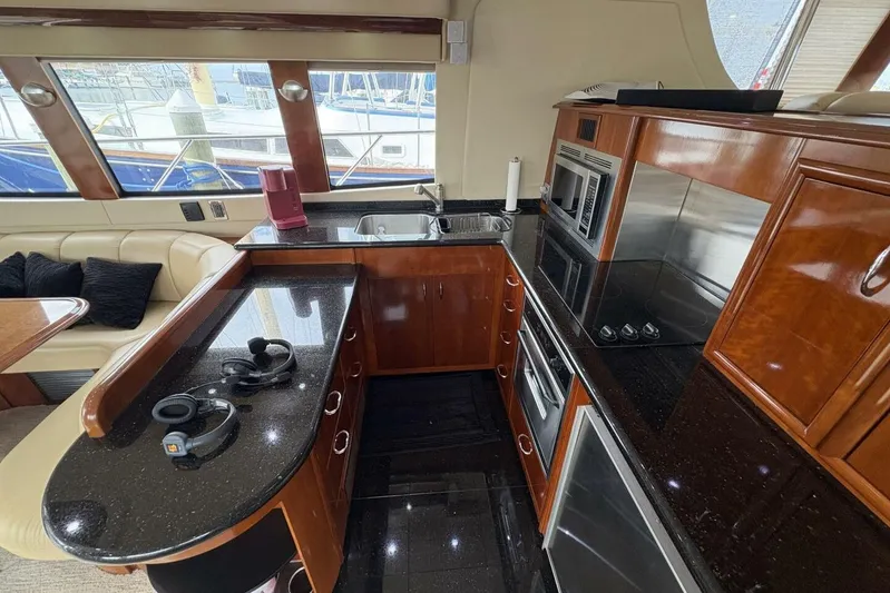 Carlet Vivian IV Yacht Photos Pics Luxurious kitchen interior of 2004 Carver 56 Voyager yacht with modern appliances.