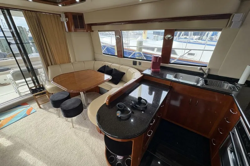 Carlet Vivian IV Yacht Photos Pics Luxurious interior of 2004 Carver 56 Voyager yacht with kitchen and dining area.