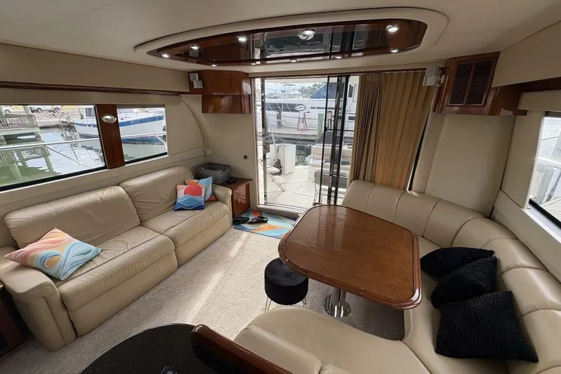 Carlet Vivian IV Yacht Photos Pics Luxurious interior of 2004 Carver 56 Voyager yacht with leather seating and wooden table.