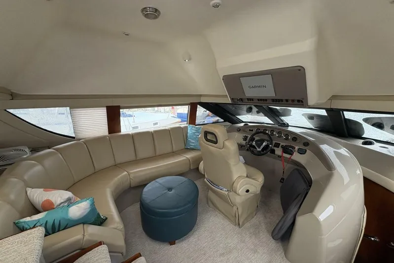 Carlet Vivian IV Yacht Photos Pics Luxurious interior of a 2004 Carver 56 Voyager yacht with plush seating and modern helm.