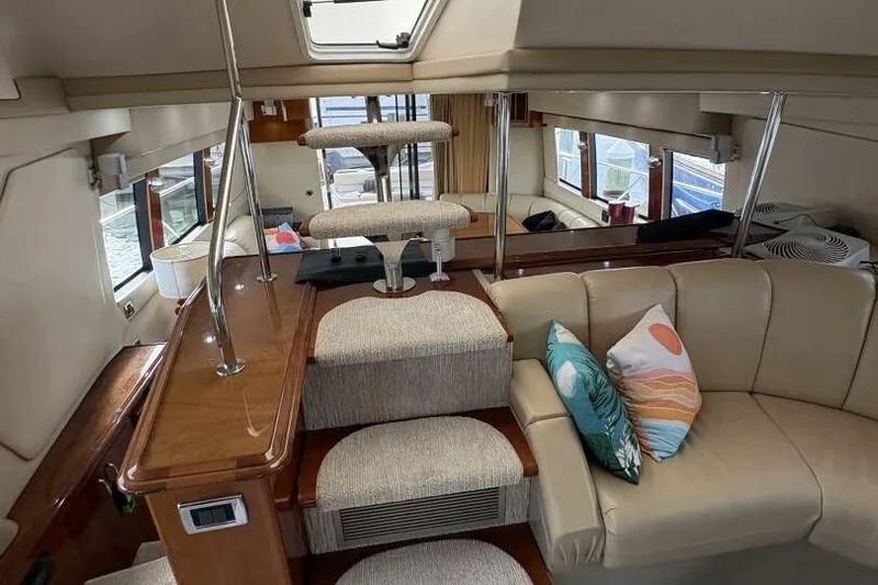 Carlet Vivian IV Yacht Photos Pics Interior of 2004 Carver 56 Voyager yacht with beige seating and decorative pillows.